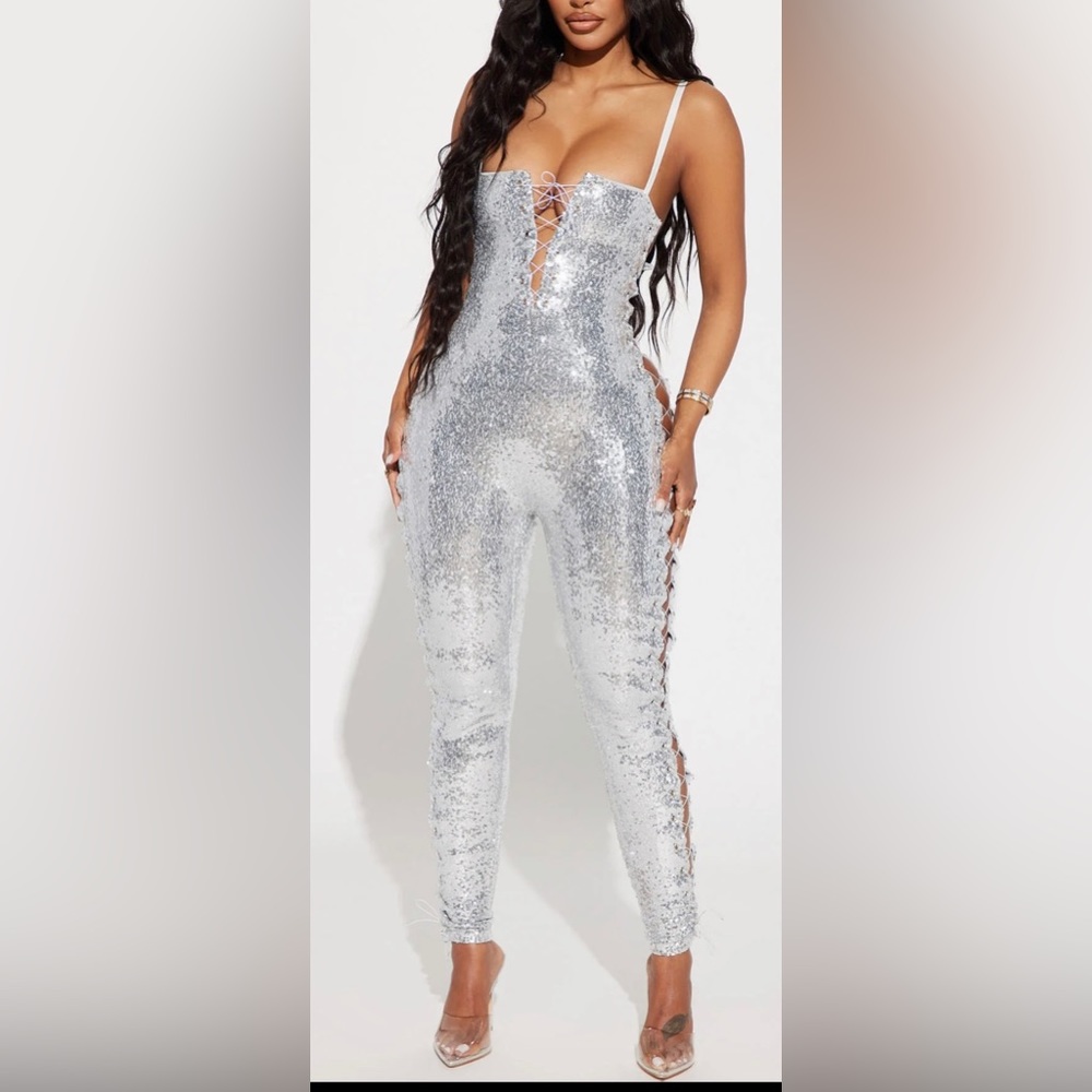Never worn. Silver sequin laced sides jumpsuit. Size medium